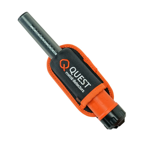 A black and orange metal detector in a black and orange protective sheath, with the brand name 'QUEST metal detectors' clearly visible on the front.