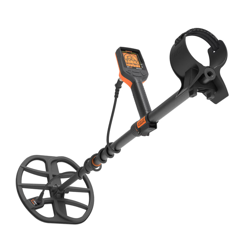 A black metal detector with an orange accent, featuring a large circular coil, a digital display screen, and a handle with a wrist strap, shown against a solid white background.