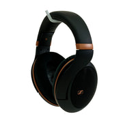 Black over-ear headphones with metallic bronze accents and a small gold Sennheiser logo on the ear cup, shown on a plain white background.
