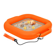 An inflatable orange  floating sifter with a gray mesh center, decorated with seashells and coins, featuring a carrying strap and black leash on a white background.