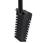 A close-up of a black shovel head with a textured surface and serrated teeth, attached to a black handle against a plain white background.